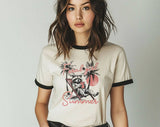 "Feral Girl Summer Raccoon Palm Tree" design on a natural ringer t-shirt with black contrast trim