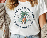 "Even The Wind & Waves Obey Him" design on a white unisex t-shirt