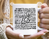 "Mama, It's Okay" design on a white ceramic coffee mug