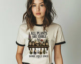 "All Plants Are Edible, Some Only Once" design on a natural ringer t-shirt with black contrast trim