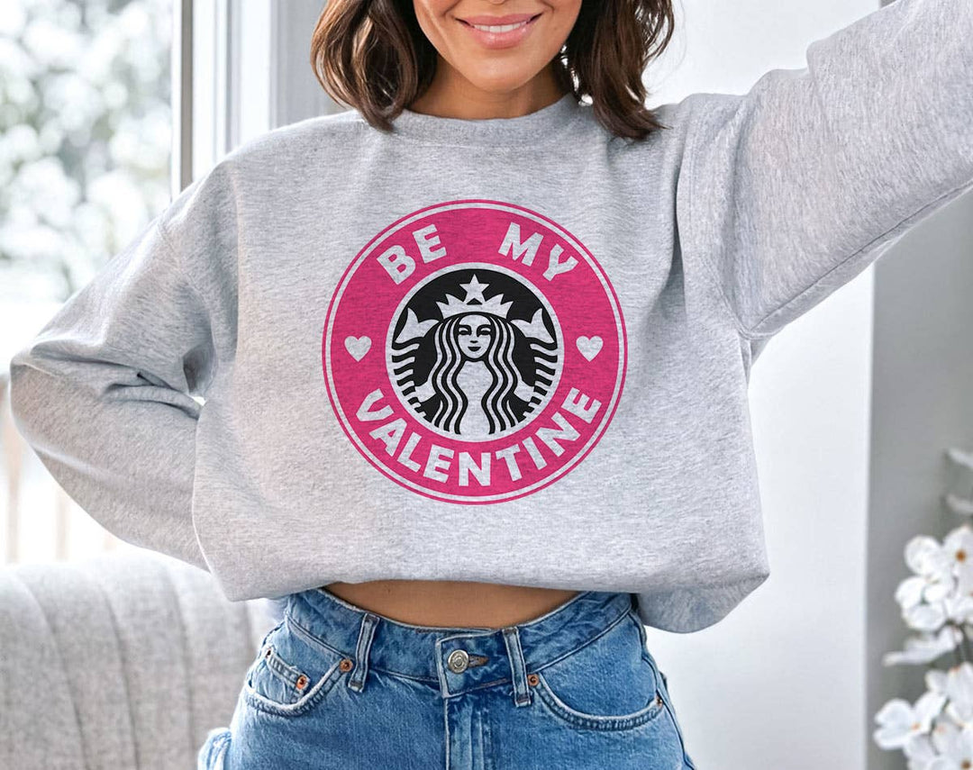 "Be My Valentine Pink Coffee Logo" design on an ash gray unisex crewneck sweatshirt