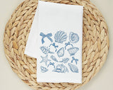 "Seashell Beach Collage" design on a white 28 x 28 inch flour sack tea towel