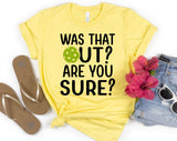 "Was That Out? Are You Sure? Pickleball" design on a pale yellow unisex t-shirt