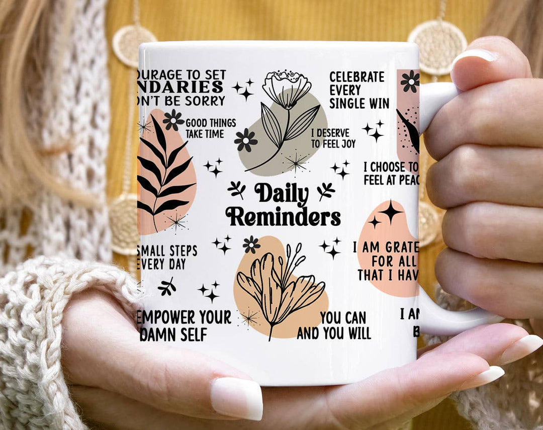 "Daily Reminders" design on a white ceramic coffee mug