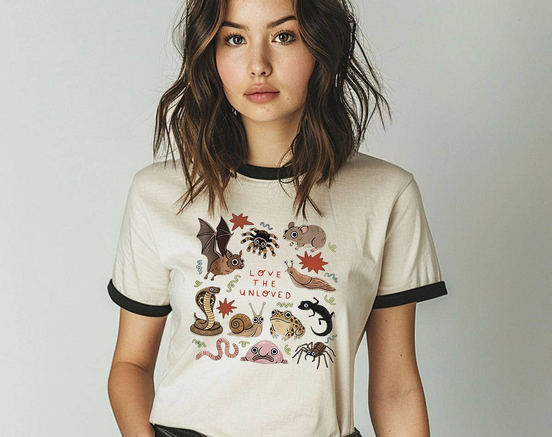 "Love The Unloved Weird Animals" design on a natural ringer t-shirt with black contrast trim