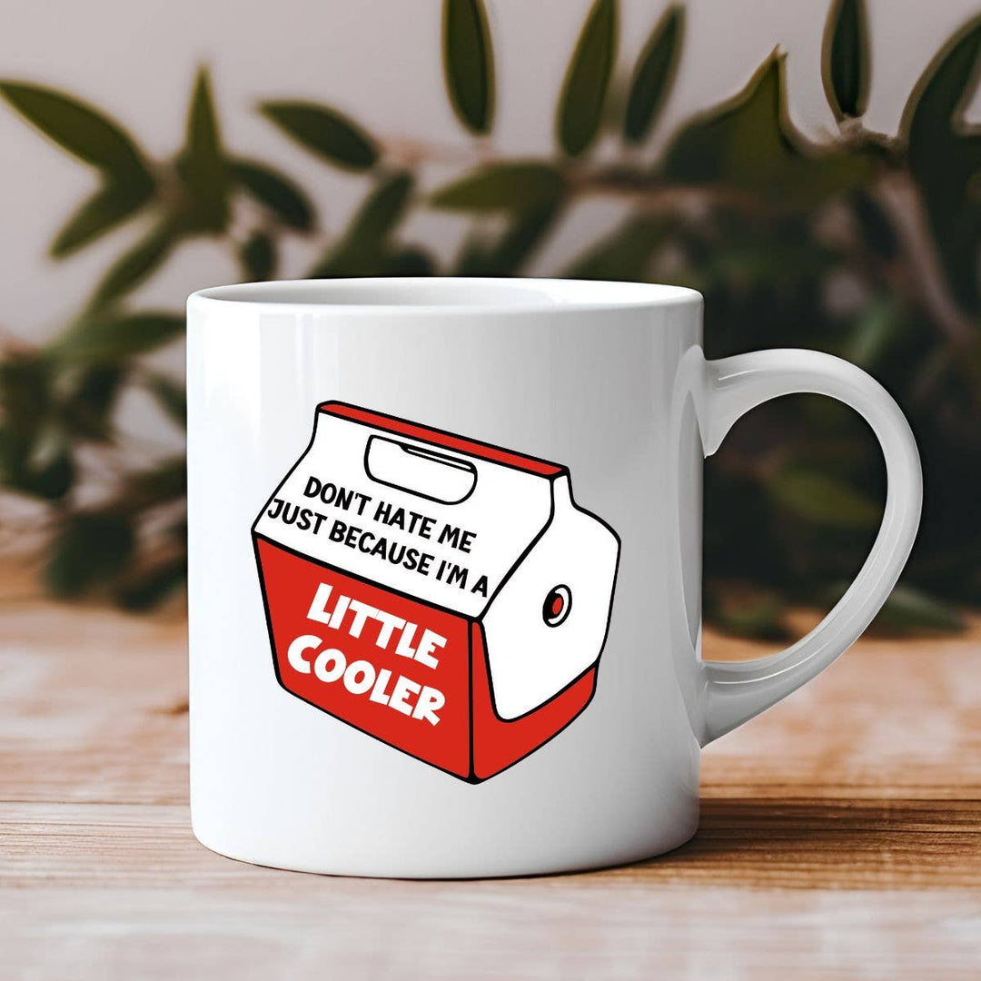 "Don't Hate Me Because I'm a Little Cooler" design on a white ceramic coffee mug