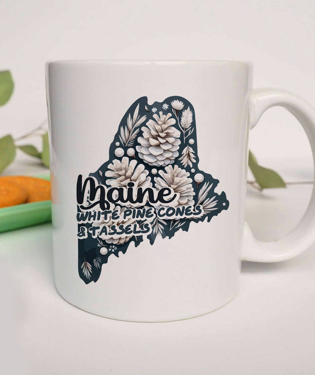 "Maine State Flower White Pine Cones & Tassels" design on a white ceramic coffee mug