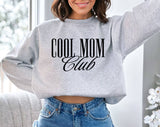 "Cool Mom Club" design on an ash gray unisex crewneck sweatshirt
