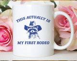 "My First Rodeo Raccoon" design on a white ceramic coffee mug