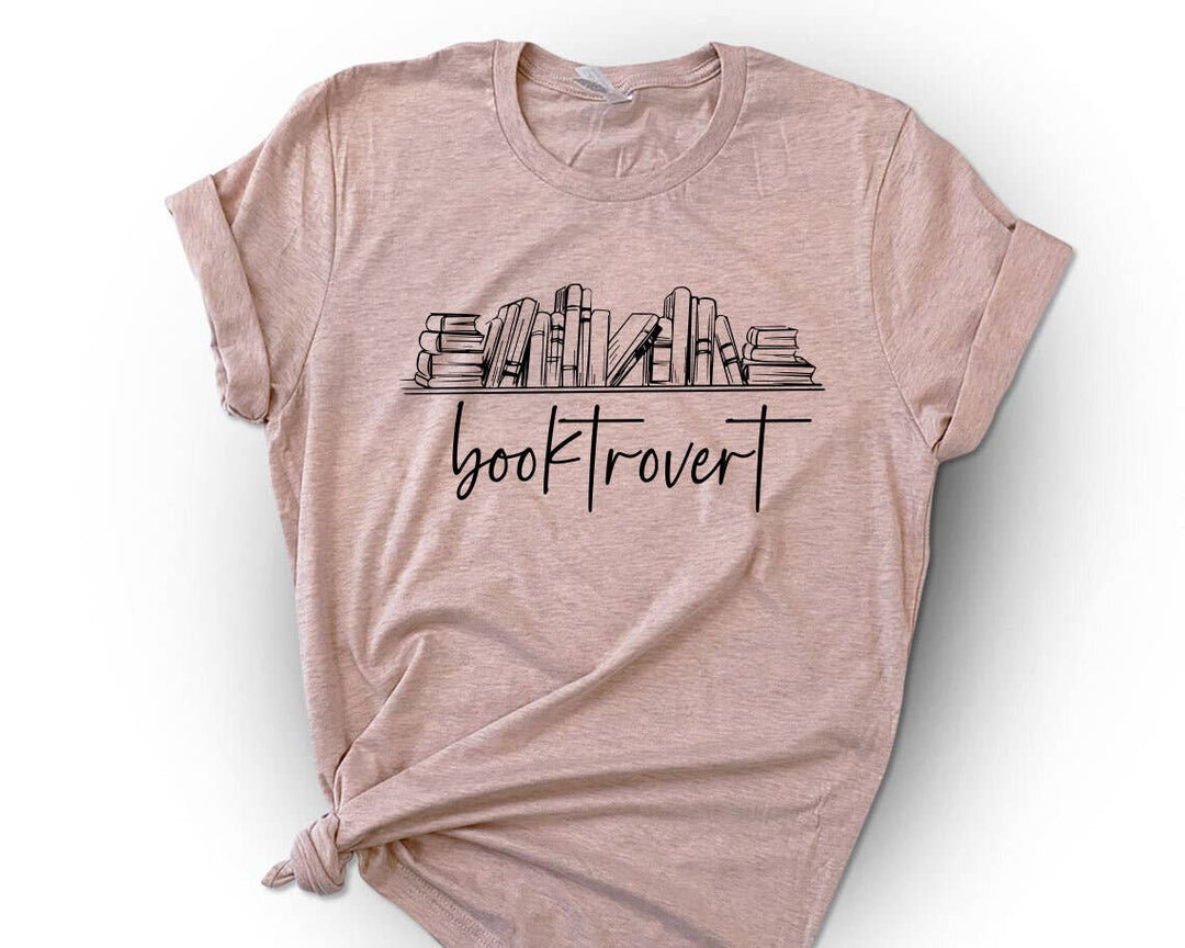 "Booktrovert Bookshelf" design on a peach unisex t-shirt