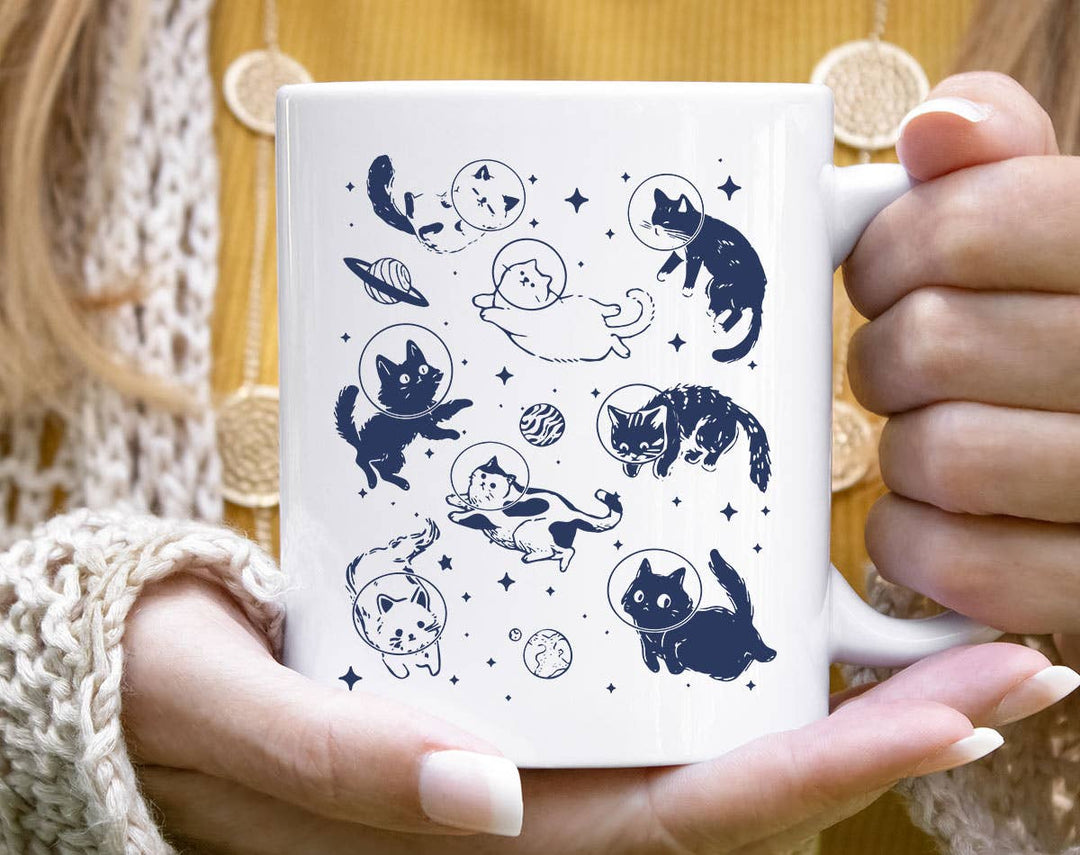 "Cats Floating In Space" design on a white ceramic coffee mug