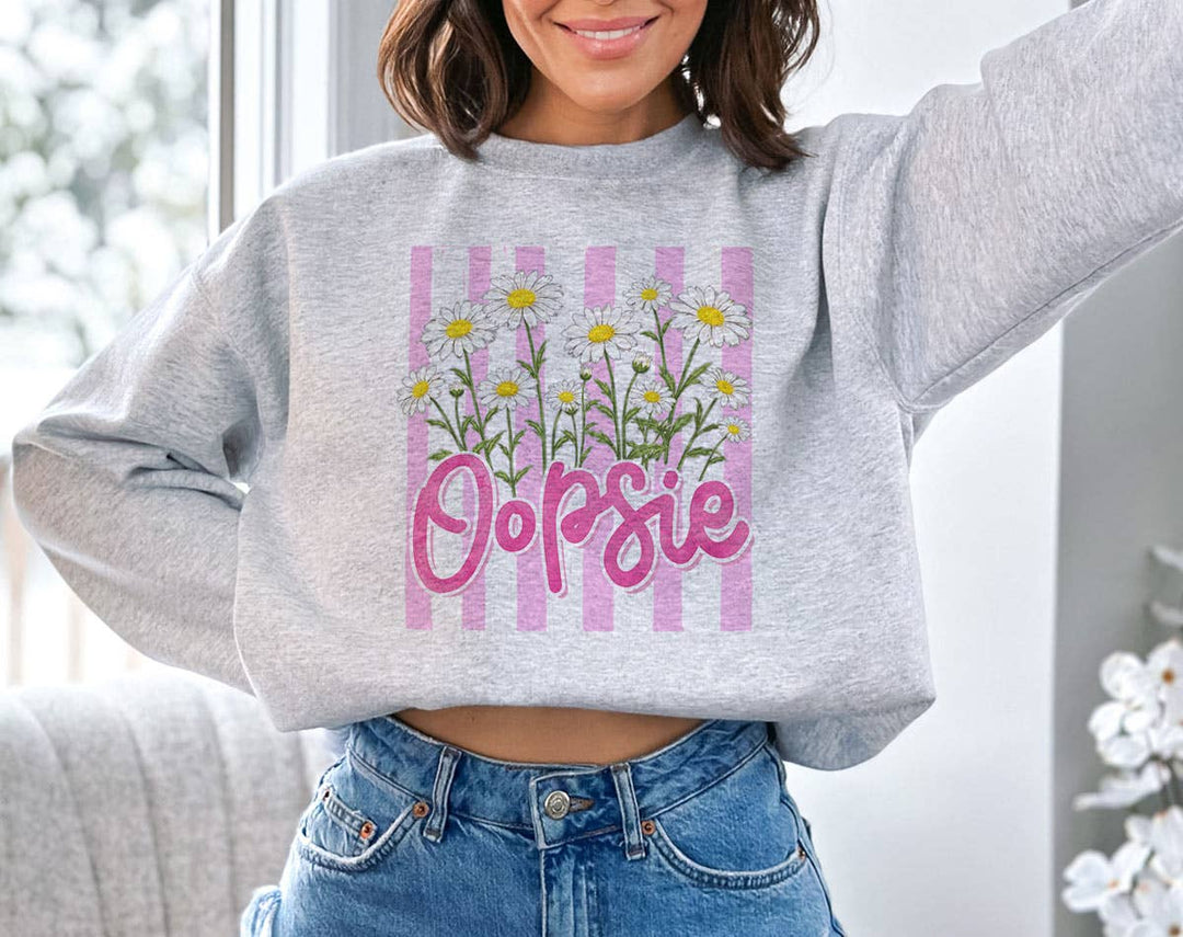 "Oopsie Daisy Flowers" design on an ash gray unisex crewneck sweatshirt