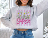 "Oopsie Daisy Flowers" design on an ash gray unisex crewneck sweatshirt