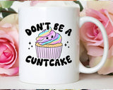 "Don't Be A Cuntcake" design on a white ceramic coffee mug