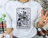 "The Plant Lover Tarot B&W" design on an ash gray unisex crewneck sweatshirt