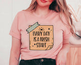 "Every Day Is A Fresh Start" design on a peach unisex t-shirt