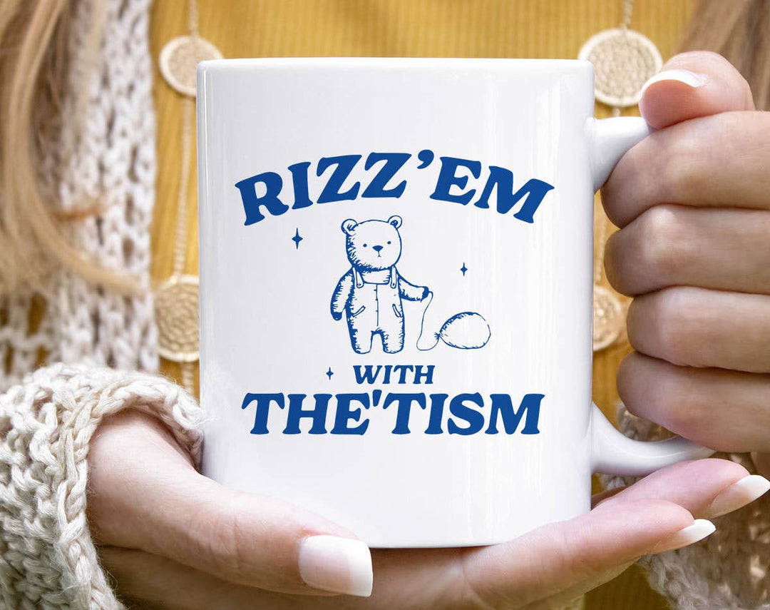 "Rizz'em With The'Tism Bear" design on a white ceramic coffee mug