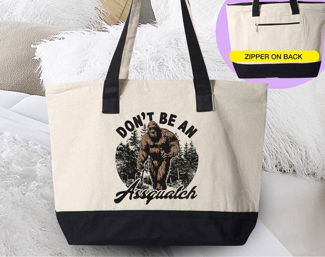 "Don't Be An Assquatch" design on a natural canvas zippered tote bag