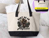 "Don't Be An Assquatch" design on a natural canvas zippered tote bag