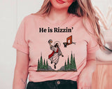 "He Is Rizzen'" design on a peach unisex t-shirt