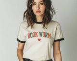 "Bookworm Heart" design on a natural ringer t-shirt with black contrast trim