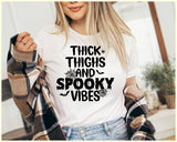 "Thick Thighs, Spooky Vibes" design on a white unisex t-shirt