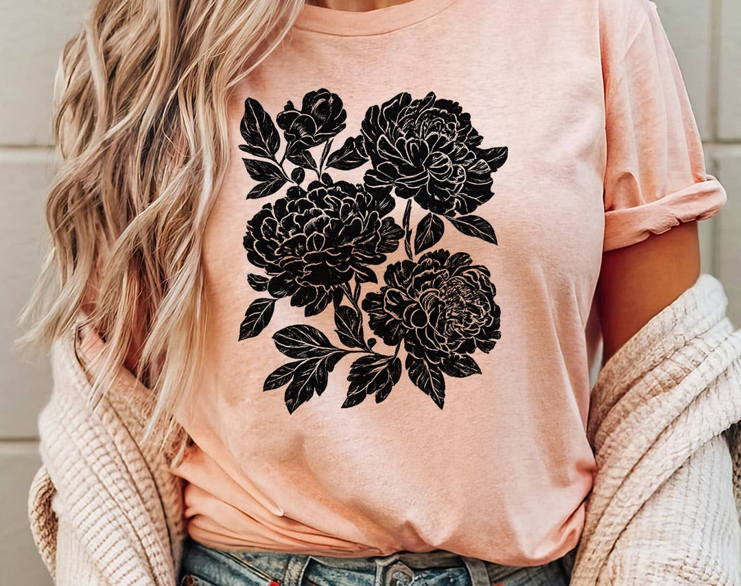 "Retro Linocut Black Peonies" design on a peach unisex t-shirt