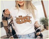 "Spooky Season Ghost" design on a white unisex t-shirt