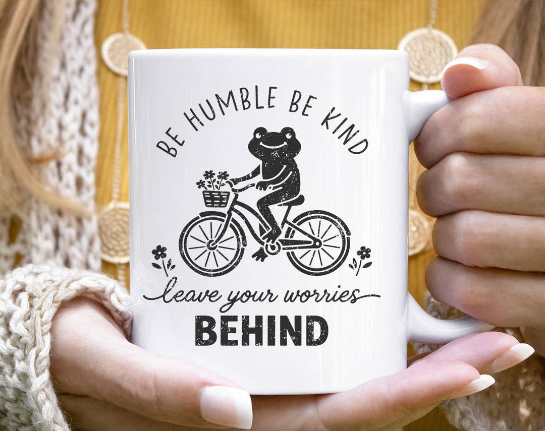 "Be Humble Be Kind Leave Worries Frog Bicycle" design on a white ceramic coffee mug