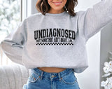 "Undiagnosed, But Something Ain't Right" design on an ash gray unisex crewneck sweatshirt