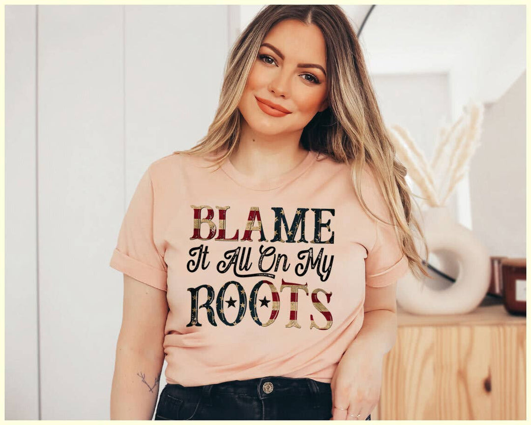 "Blame It All On My Roots" design on a white unisex t-shirt