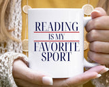 "Reading Is My Favorite Sport" design on a white ceramic coffee mug