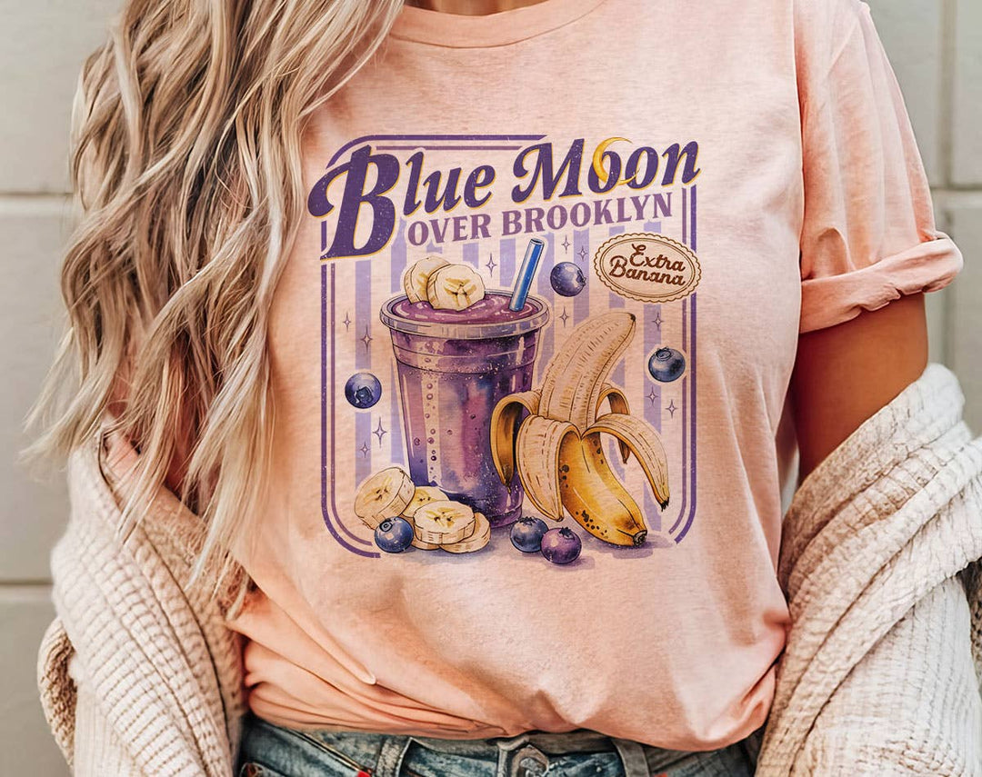 "Blue Moon Over Brooklyn Heated Rivalry" design on a peach unisex t-shirt