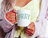 "Pray Blue" design on a white ceramic coffee mug