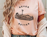 "Never Better Skeleton Coffin" design on a peach unisex t-shirt
