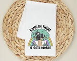 "Hang In There, It Gets Worse Cat" design on a white 28 x 28 inch flour sack tea towel