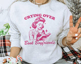 "Crying Over Book Boyfriends" design on an ash gray unisex crewneck sweatshirt