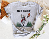 "He Is Rizzen'" design on a heather gray unisex t-shirt