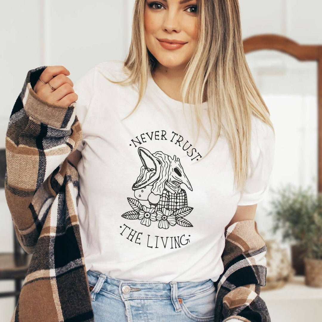 "Never Trust The Living" design on a unisex t-shirt