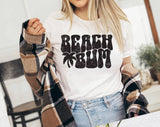 "Beach Bum" design on a white unisex t-shirt