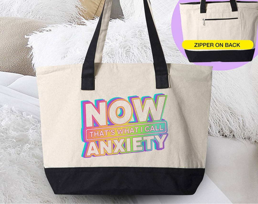 "Now That's What I Call Anxiety" design on a natural canvas zippered tote bag