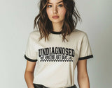 "Undiagnosed, But Something Ain't Right" design on a natural ringer t-shirt with black contrast trim