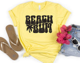 "Beach Bum" design on a pale yellow unisex t-shirt