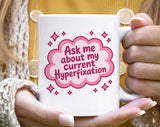 "Ask Me About My Current Hyperfixation Adhd" design on a white ceramic coffee mug