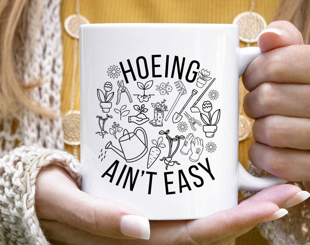 "Hoeing Ain't Easy" design on a white ceramic coffee mug