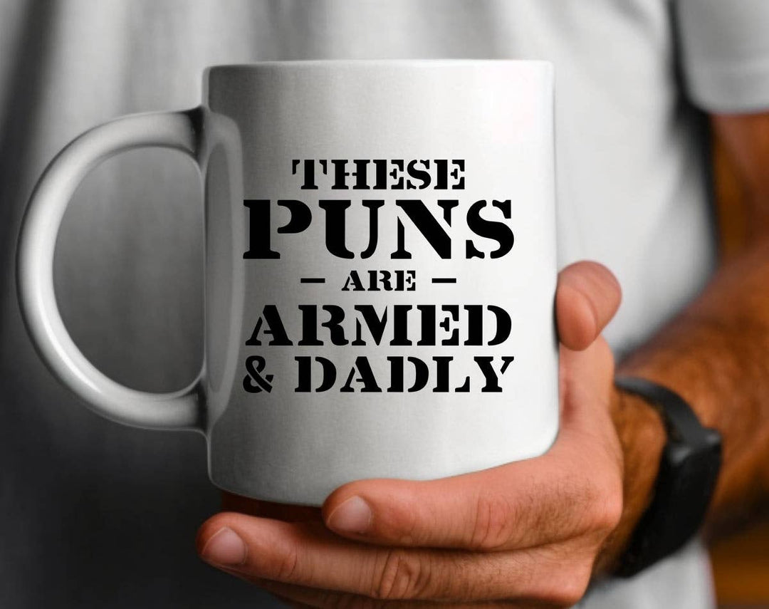 "These Puns Armed & Deadly" design on a white ceramic coffee mug
