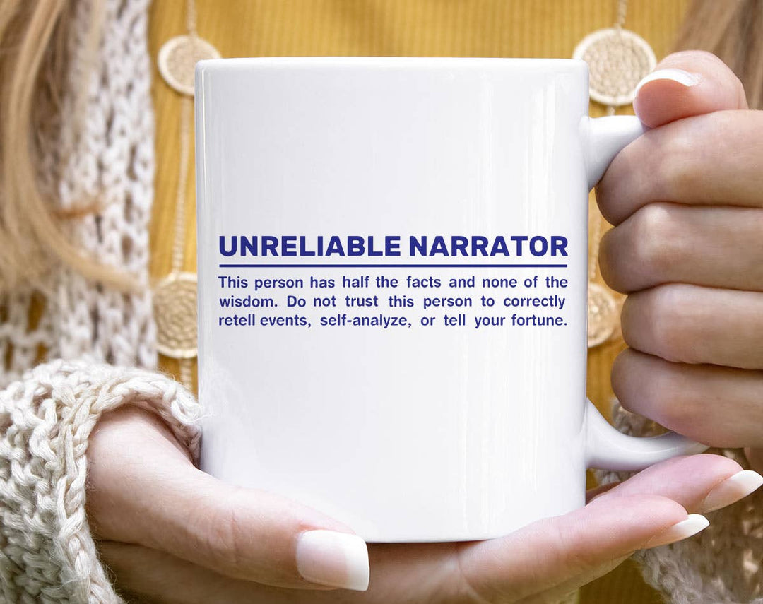 "Unreliable Narrator" design on a white ceramic coffee mug