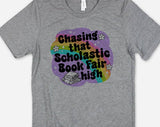 "Chasing That Scholastic Book Fair High" design on a heather gray unisex t-shirt