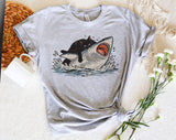 "Cat Riding Shark" design on a heather gray unisex t-shirt