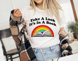 "Take A Look, It's In A Book" design on a white unisex t-shirt